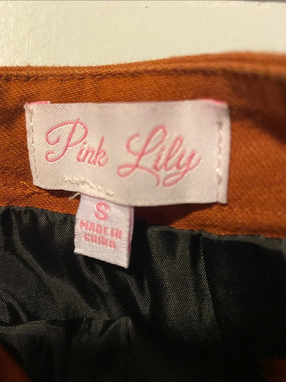 Pink Lily Rust Button-Front Ruffle Hem Mini Skirt with shorts liner/slip